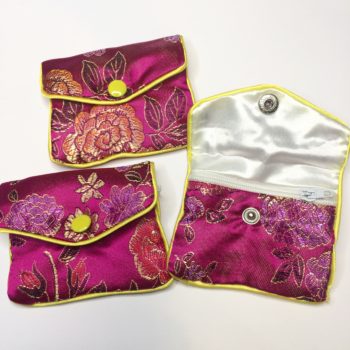 The front of three unique Pink Floral Crystal Pouch