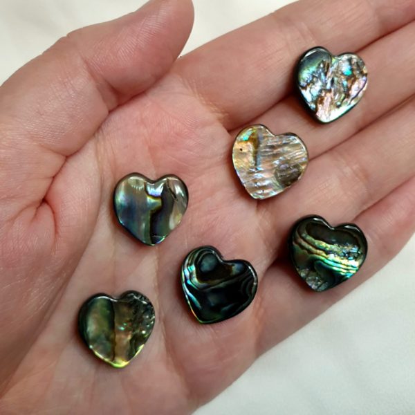 6 unique heart shaped abalone shell beads in my hand