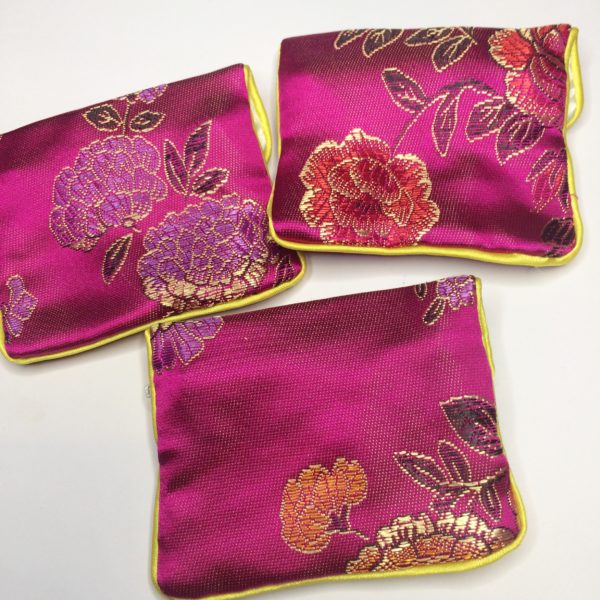 The backs of three unique Pink Floral Crystal Pouch