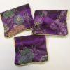 The back of three unique purple Floral Crystal Pouch