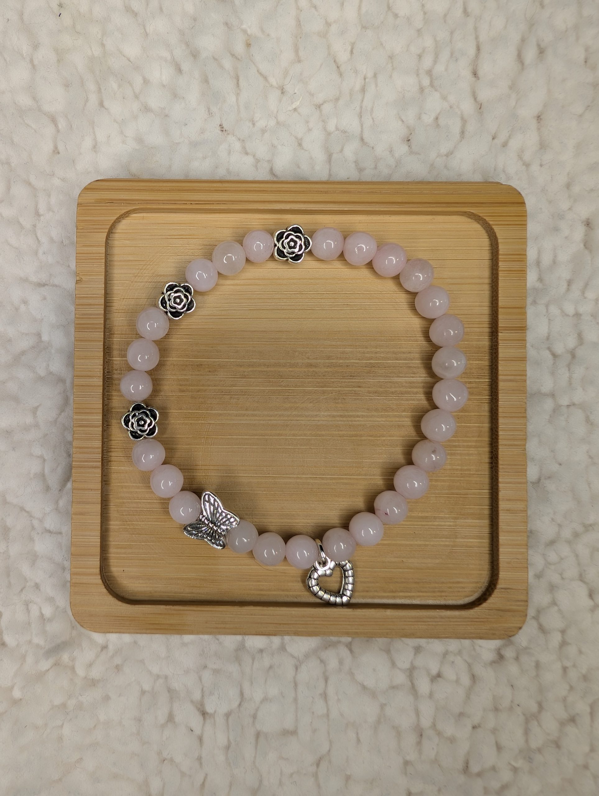 6mm Rose Quartz bracelet with 3 silver flower beads, 1 butterfly bead and a heart charm